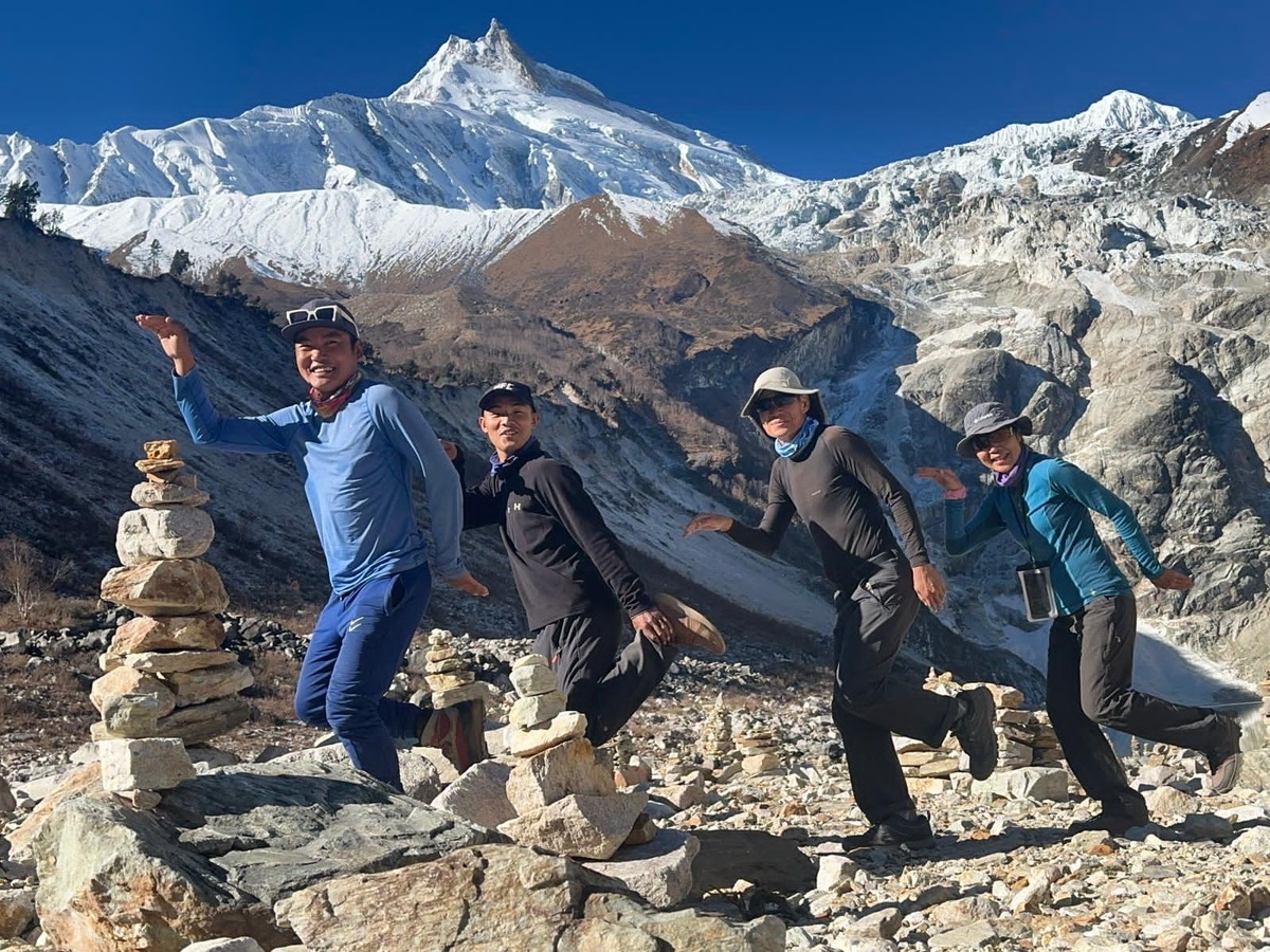 How Difficult is it to Trek the Manaslu Circuit Trek? manaslu circuit trek nepal posing infront of Mountain